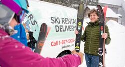 Man delivering skis to a woman
